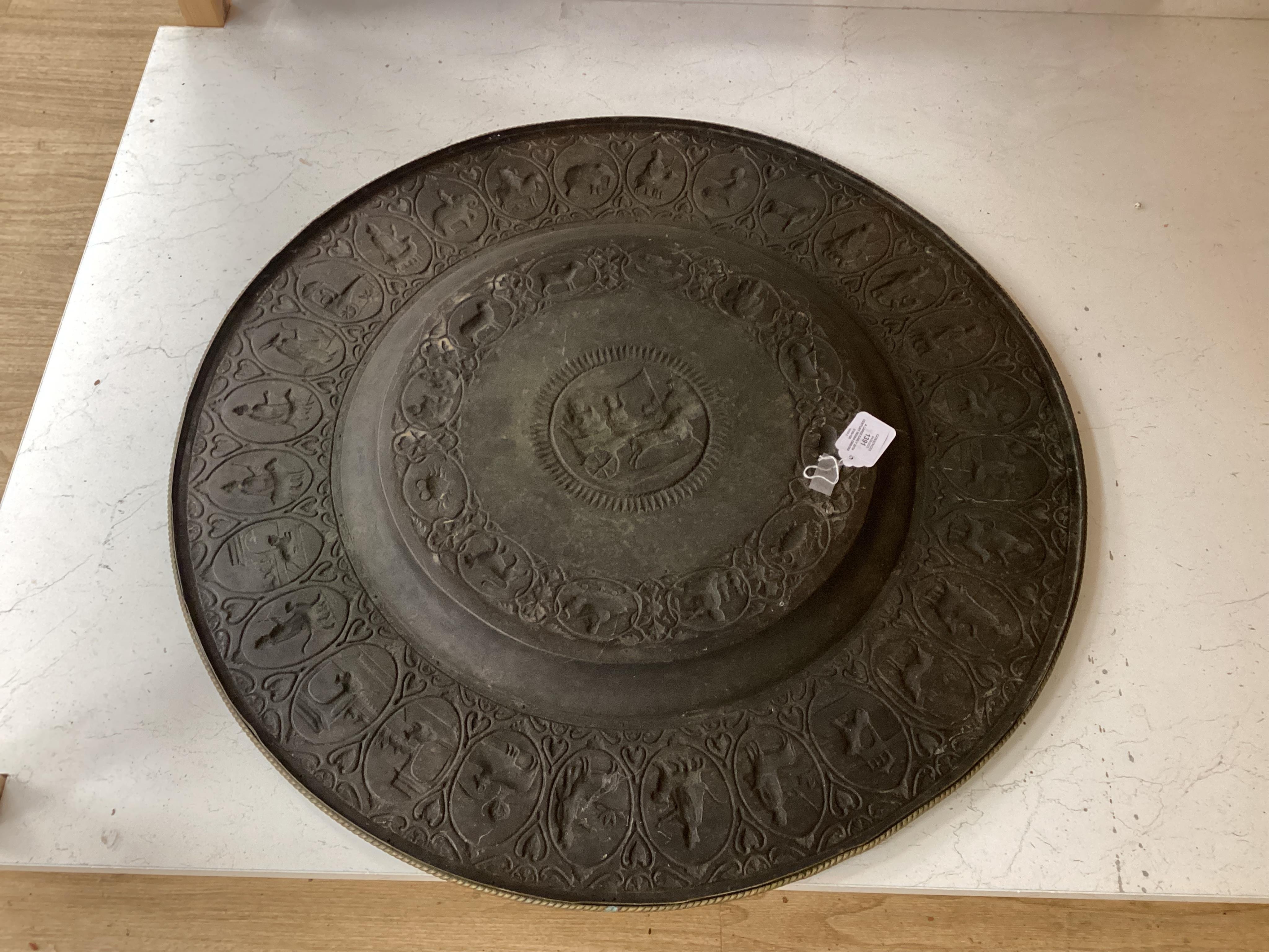 A large early 20th century Indian embossed brass tray, 78cm in diameter
